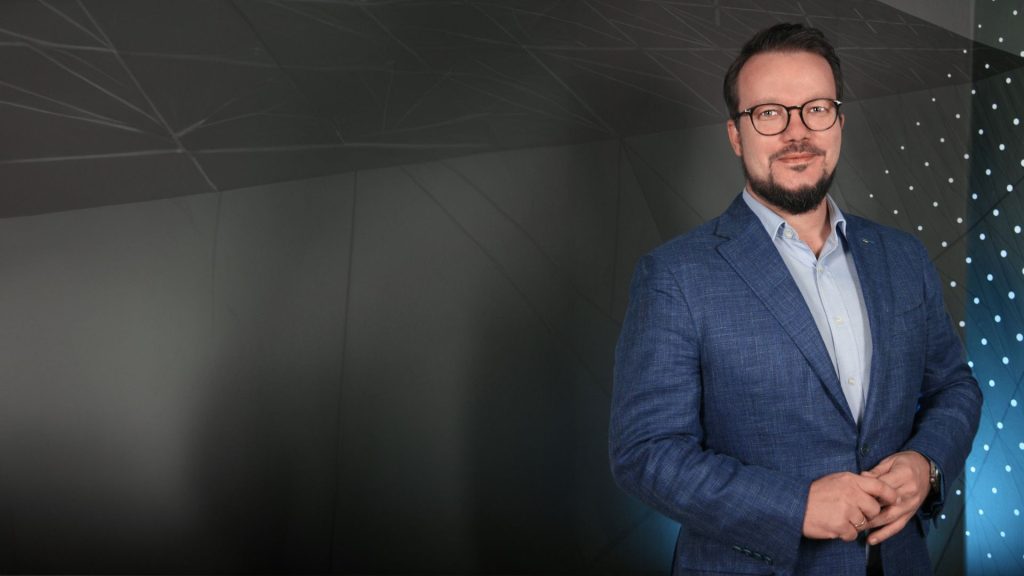 Berthold posing in a suit