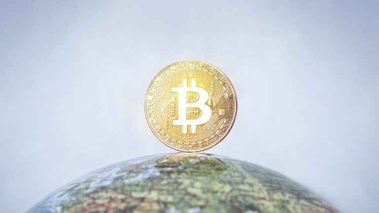 Bitcoin floating over globe