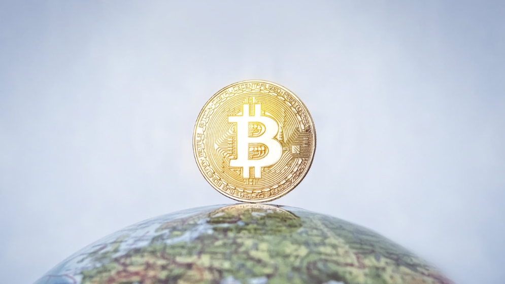 Bitcoin floating over globe
